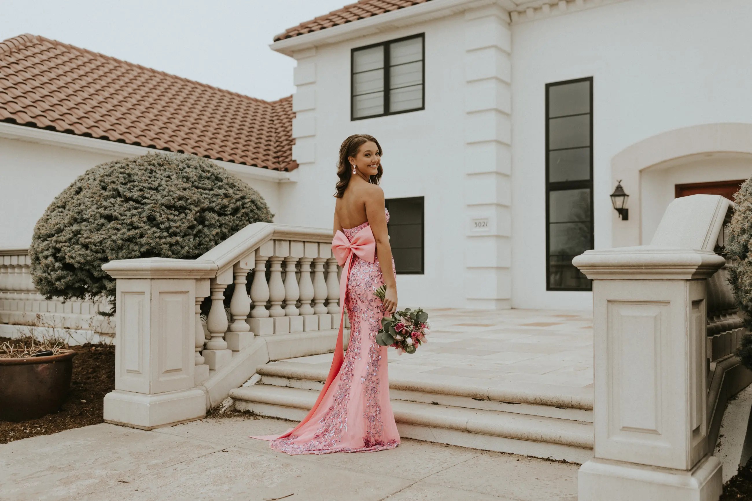 Two teen girls wearing a long yellow and blue prom dress